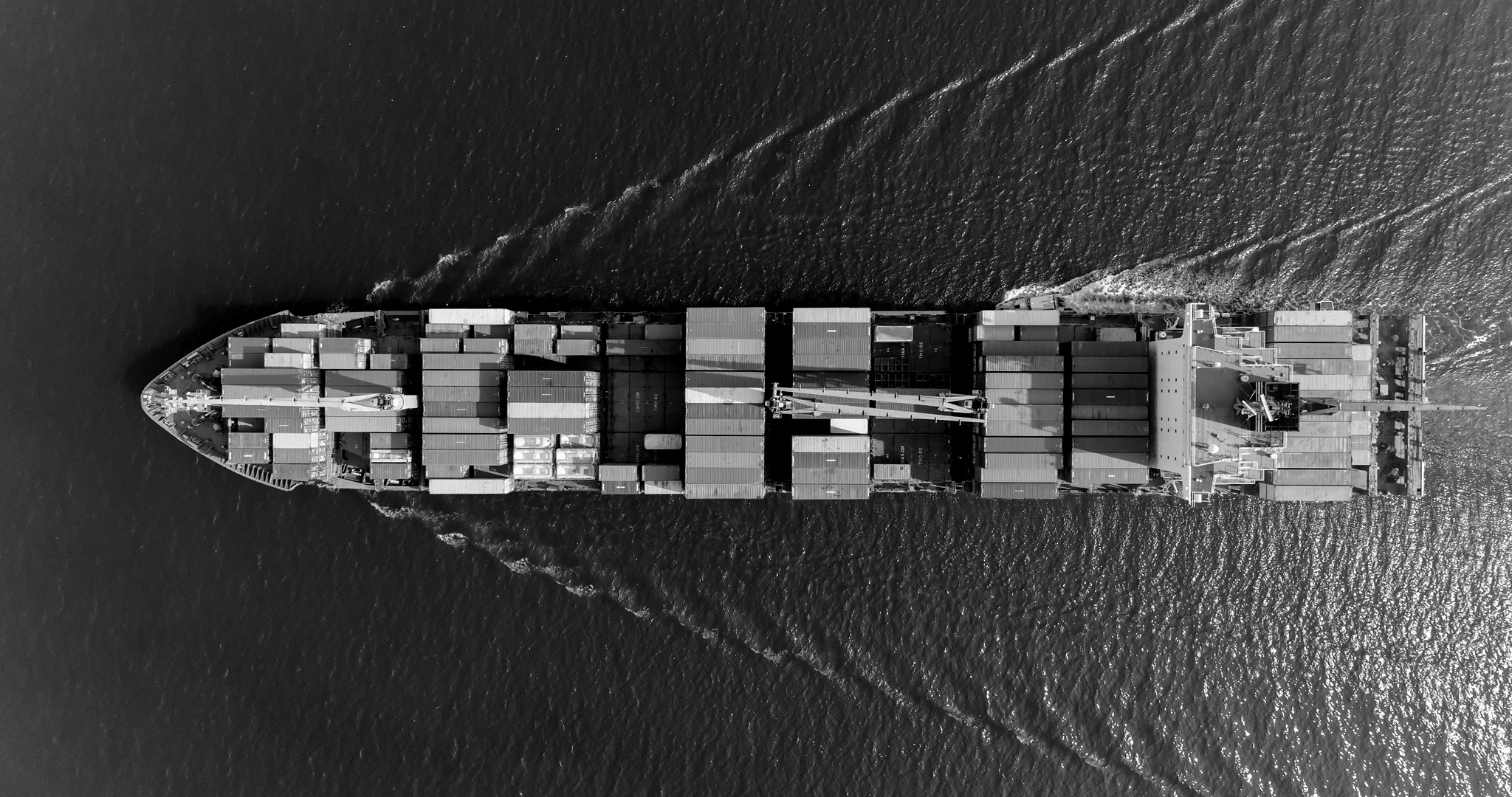 Aerial view of container cargo ship in sea.